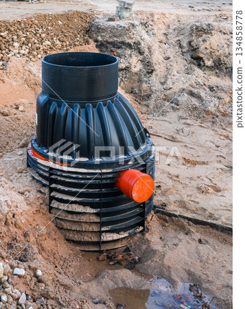 Plastic underground drainage manhole chamber installation at site with exposed soil trench Plastic underground drainage manhole chamber installation at site with exposed soil trench 134858778