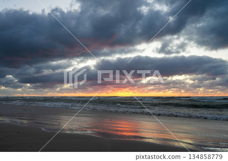 Dramatic Winter Sunset Over Baltic Sea Waves at Dusk on the Beach in Liepaja, Latvia 134858779