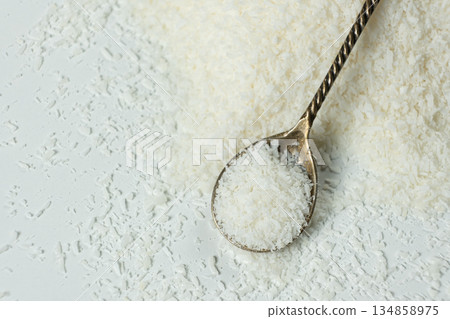 Chopped dried coconut flakes in a macro spoon 134858975