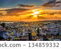 Beautiful sunset over cityscape of Lisbon, Portugal, historic center, Tagus river with dramatic clouds, famous Ponte 25 de Abril or April 25th bridge silhouette, sunlight, colorful tiled rooftops 134859332