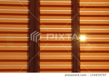 Modern jalousie day and night horizontal. Sunny ray making its way through blinds 134859797