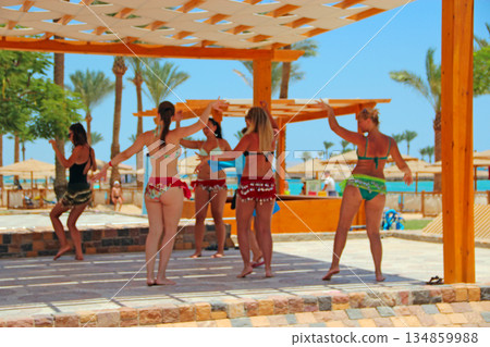 Women dancing. Beach clothes. Women enjoying dancing while summer holidays 134859988