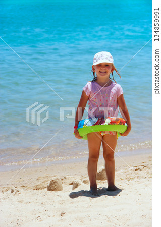 Little girl with inflatable circle on summer holidays at sea. Rest on resort 134859991