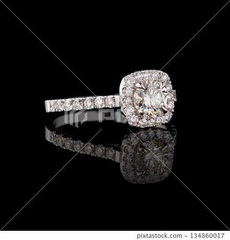 Beautiful white gold ring with diamonds on a black background 134860017