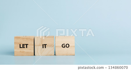 Wooden cubes with inscriptions Let It Go on a blue background 134860070