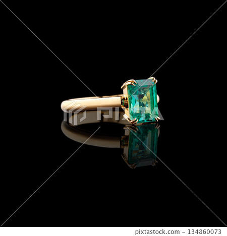 Beautiful yellow gold ring with diamonds and emerald on a black background 134860073