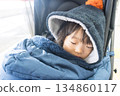 Japanese girl toddler wrapped in a sleeping bag in a stroller 134860117