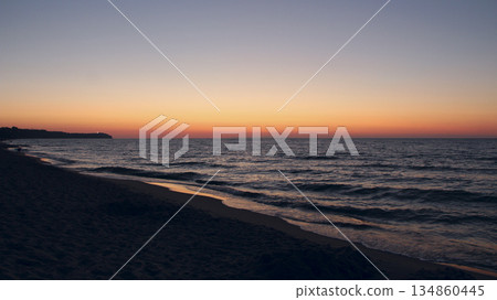 Sunset on Baltic Sea. Waves on seashore in evening Sunset on Baltic Sea. Waves on seashore in evening 134860445