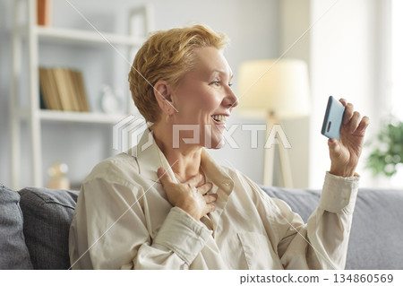 Senior phone user, elderly grandmother spends good time having fun using video smartphone apps 134860569