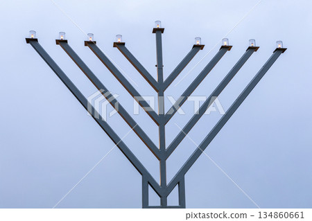 Jewish Hanukkiah candles shining against blue sky Jewish Hanukkiah candles shining against blue sky 134860661