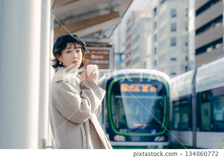 Lifestyle scene of a woman in her 30s drinking coffee on the station platform 134860772