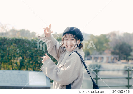 A woman in her 30s walking happily while exploring a tourist spot A woman in her 30s walking happily while exploring a tourist spot 134860846