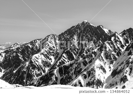 The summit of Mount Tsurugi seen from the hiking trail of Mount Oku-Dainichi. Climbing Mount Oku-Dainichi in the Northern Alps during the snowy season. For newspaper advertisement. The summit of Mount Tsurugi seen from the hiking trail of Mount Oku-Dainichi. Climbing Mount Oku-Dainichi in the Northern Alps during the snowy season. For newspaper advertisement. 134864052