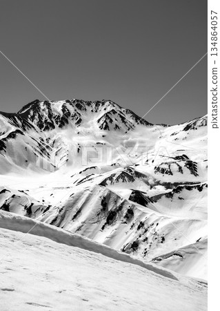 Mount Oono, the main peak of the Tateyama mountain range seen from Mount Oku-Dainichi. Climbing Mount Oku-Dainichi in the Northern Alps during the snowy season. For newspaper advertisement. 134864057