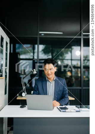 Man freelancer is working her job on computer tablet and laptop Doing accounting analysis report real estate Man freelancer is working her job on computer tablet and laptop Doing accounting analysis report real estate 134864996