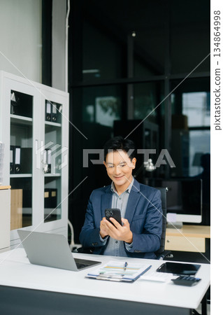 Man freelancer is working her job on computer tablet and laptop Doing accounting analysis report real estate 134864998