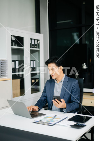 Man freelancer is working her job on computer tablet and laptop Doing accounting analysis report real estate 134864999