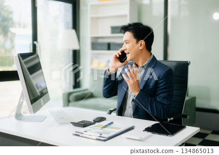 Asian businessman are delighted and happy with the work they do on their tablet, laptop and taking notes Asian businessman are delighted and happy with the work they do on their tablet, laptop and taking notes 134865013