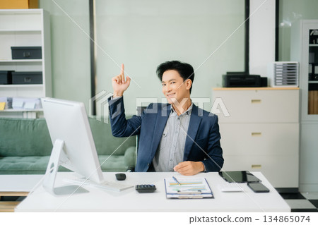 Young attractive Asian male office worker business suits smiling at camera 134865074