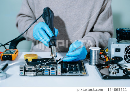 Electronics technician, electronic engineering electronic repair, electronics measuring and testing, repair and maintenance concepts.uses a voltage meter to check Electronics technician, electronic engineering electronic repair, electronics measuring and testing, repair and maintenance concepts.uses a voltage meter to check 134865511