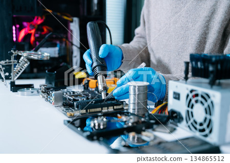 Electronics technician, electronic engineering electronic repair, electronics measuring and testing, repair and maintenance concepts.uses a voltage meter to check Electronics technician, electronic engineering electronic repair, electronics measuring and testing, repair and maintenance concepts.uses a voltage meter to check 134865512