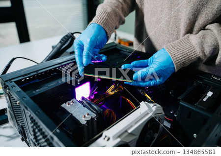 Electronics assembly and RAM installation with high-tech components. Ideal for showcasing advanced technology and computer engineering concepts 134865581