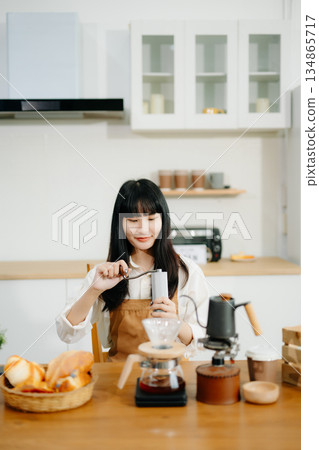 Asian barista brewing fresh espresso. Enjoy a cozy, trendy cafe experience with high quality beans in home or cafe 134865717