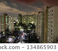 Stunning Night View of Modern Korean Apartment Complex with Illuminated Windows and Urban Atmosphere 134865903