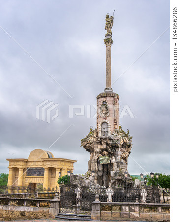 Statue of Saint Raphael and Puerta del Puente in Cordoba Spain. 134866286