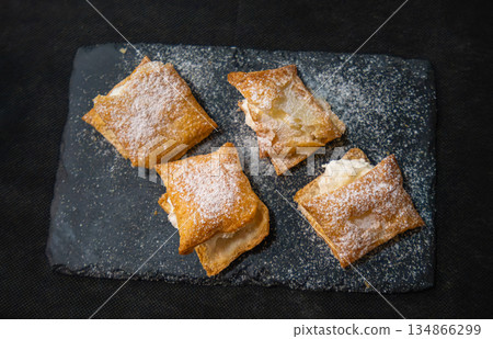 Cream-filled pastries dusted with sugar served in Consuegra, Spain. 134866299