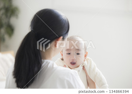 Young mother taking care of her baby 134866394