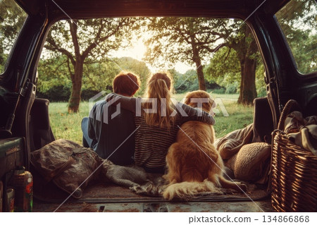 Couple Enjoying Scenic Picnic During Road Trip with Dog in Nature at Golden Hour Couple Enjoying Scenic Picnic During Road Trip with Dog in Nature at Golden Hour 134866868