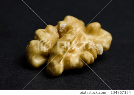 Macro Shot of Single Walnut Kernel on Black Background. High quality photo Macro Shot of Single Walnut Kernel on Black Background. High quality photo 134867334