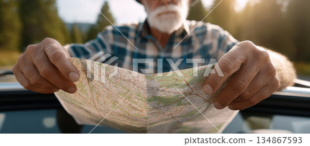 Active senior happy retirement elderly health aging society man holding road map outdoors during scenic road trip in nature enjoying exploration and wellbeing 134867593