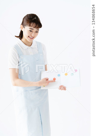 A nursery school teacher holding a picture book 134868654