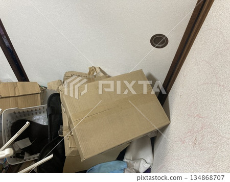 Empty cardboard boxes and other unwanted items piled up at the entrance to the Japanese-style room Empty cardboard boxes and other unwanted items piled up at the entrance to the Japanese-style room 134868707