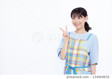 Housewife making a peace sign Housewife making a peace sign 134869650
