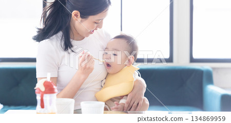 Baby eating baby food 134869959