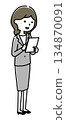 A woman in a suit that operates a tablet 134870091