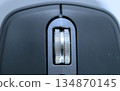 Close-up of the metal scroll wheel on a wireless mouse 134870145