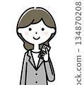 A woman with a suit with a smartphone 134870208