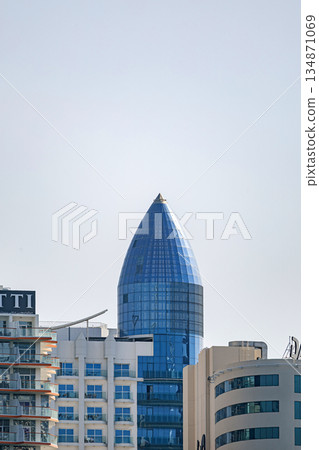 Blue glass skyscraper building with distinctive pointed top, architecture Blue glass skyscraper building with distinctive pointed top, architecture 134871069