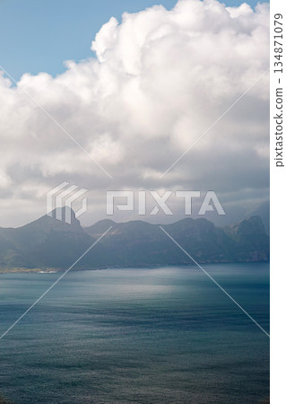 Blue ocean with mountain range in background on partly cloudy day, South Africa Blue ocean with mountain range in background on partly cloudy day, South Africa 134871079