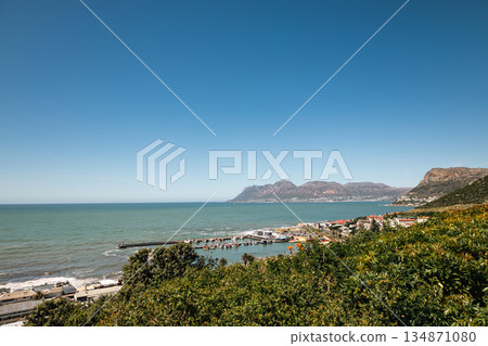 Coastal town with a harbor and mountains. South African landscape Coastal town with a harbor and mountains. South African landscape 134871080