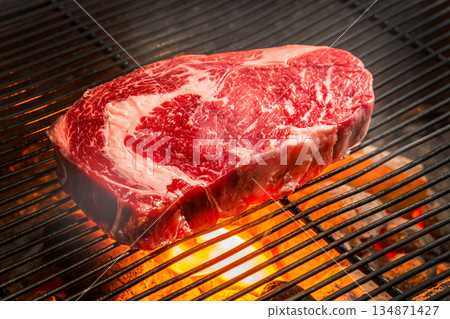Grill a steak over an outdoor 134871427