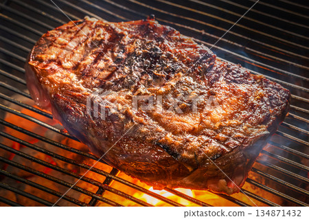 Grill a steak over an outdoor Grill a steak over an outdoor 134871432