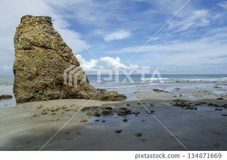 Close seastack portrait with weathered rock surfaces, shallow surf, and crisp blue sky, Kuala Penyu, Sabah, Malaysia. Close seastack portrait with weathered rock surfaces, shallow surf, and crisp blue sky, Kuala Penyu, Sabah, Malaysia. 134871669