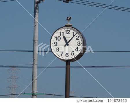 The electric wires stretching into the blue sky and the clock symbolize time and everyday life. The electric wires stretching into the blue sky and the clock symbolize time and everyday life. 134872333