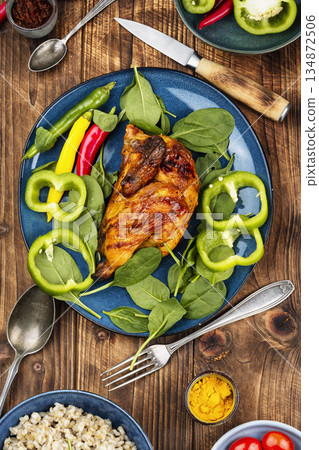 Baked grilled chicken on rustic wooden table. 134872506