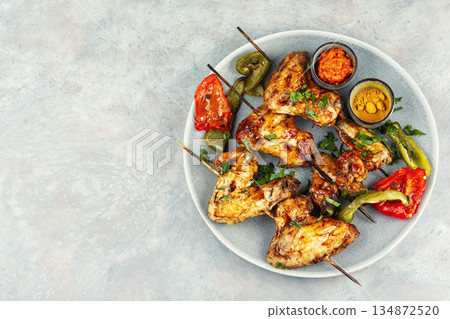 Grilled Chicken Wings on Wooden Skewers Grilled Chicken Wings on Wooden Skewers 134872520